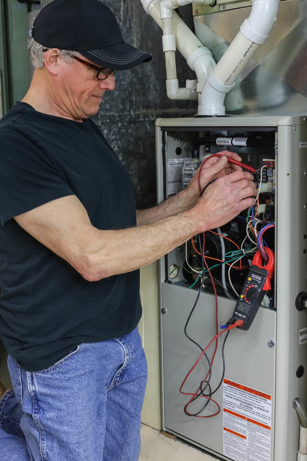 HVAC Technician repairing furnace